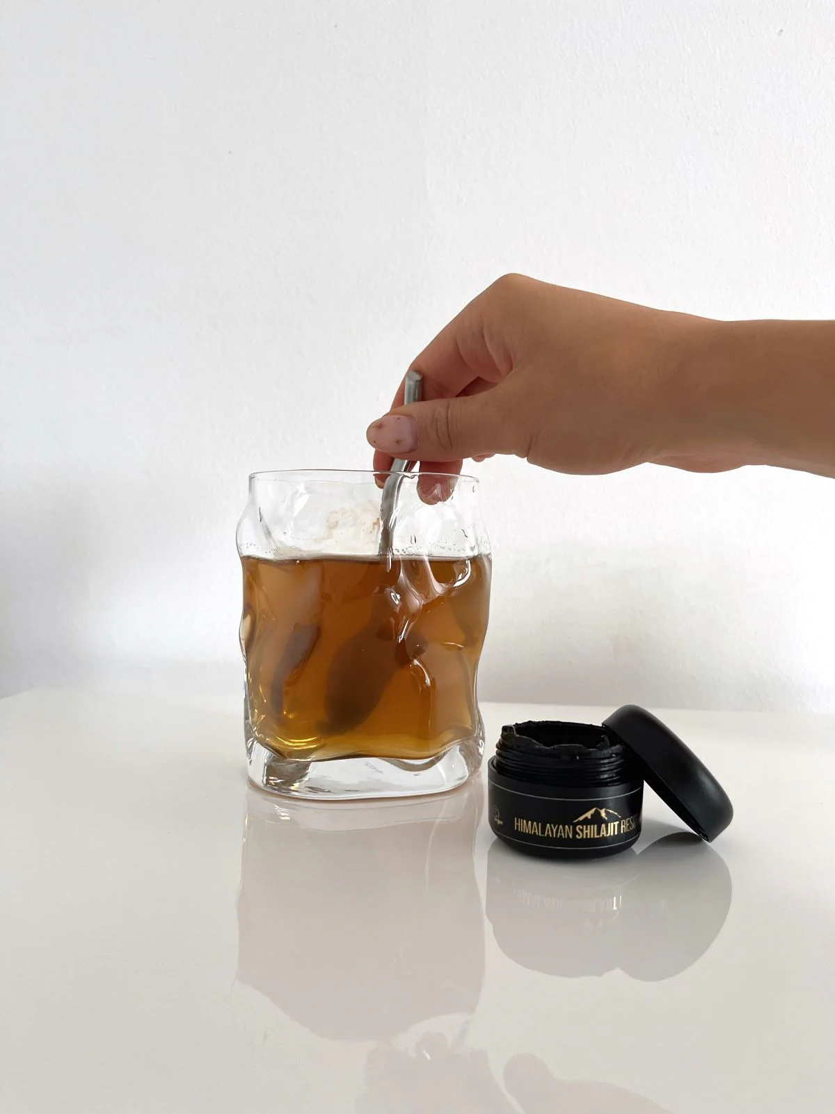 Shilajit resin dissolved in a glass of warm water